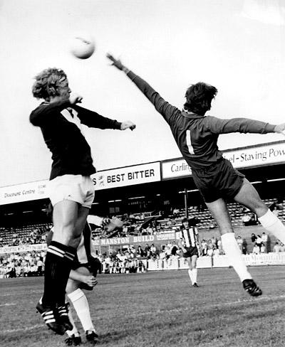06/08/1975 - Friendly match at Bootham Crescent... Jimmy Seal goes up to meet a left wing cross but is beaten to it by Sheffield Wednesday goalkeeper Peter Fox who punches away.