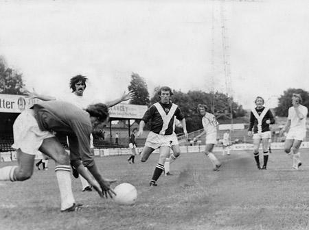 Pre-season 1975: Phil Tingay, the Chesterfield goalkeeper, scoops the ball away from City midfielder Eric McMordie.