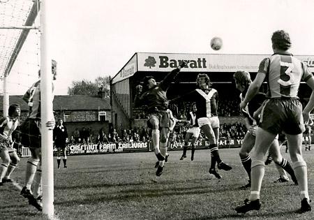 27/09/75 - York City 2, Oxford 0: Oxford 'keeper Roy Burton punches away a left wing cross under pressure from City's Chris Jones.