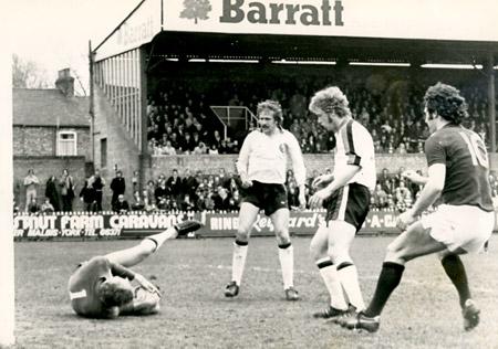 10/04/76 - York City 3, Plymouth 1: Furnell the Plymouth keeper dives to save a header from Jimmy Hinch with Micky Cave rave in for any slips.