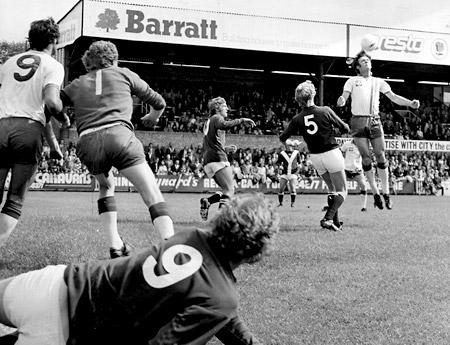 16/08/75 - York City 2, Portsmouth 1: Eoin Hand, Portsmouth's centre back, heads away from City skipper Barry Swallow.