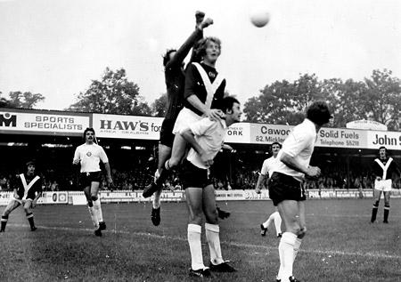 30/08/75 - York City 1, Bolton 2: Mid-air battle as Bolton 'keeper Barry Siddall punches the ball off the head of City skipper Barry Swallow.