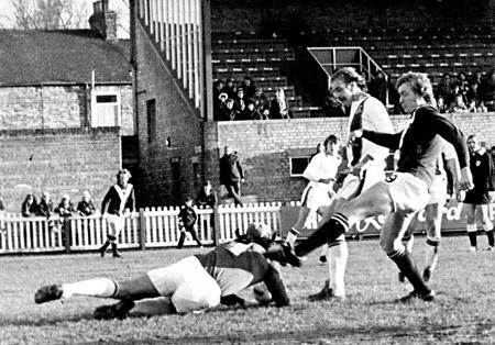07/02/76 - York City 2, Luton Town 3: Horne, the Luton goalkeeper dives at the feet of Jimmy Seal, just beating the City forward to the ball.