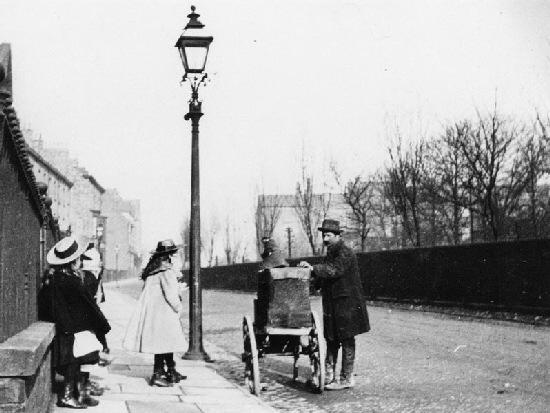 Children watch an organ grinder and his monkey in Bootham Terrace, York.