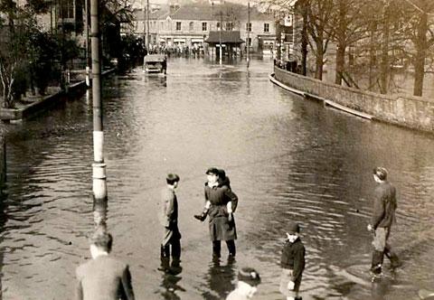 Children playing in the water outside York Carriage Works.  The crowds in the background at the junction to Poppleton Road and Holgate Road may well be waiting for transport through the water