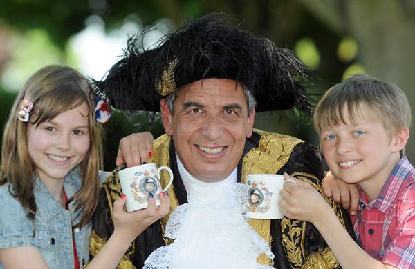 Wigginton School pupils Imogen Bell and Joseph Olney with the Lord Mayor of York, Coun Keith Hyman, after receiving their Jubilee mugs