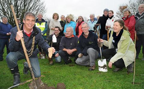 The Lord Mayor of York, Keith Hyman, plants the sapling at Willow Bank in New Earswick, as part of a scheme in which volunteers, some of whom are pictured, planted 420 trees