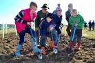 Volunteers pitch in to plant 600 native trees in a new wood in Holtby
