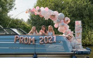 Rosie Henderson Holmes, Alex Shepherd and Tianna Wigginton, of Huntington School, York, were whisked away to a night to remember via boat decked out with rose-gold balloons spelling out 'Prom 2021'. Photo by Heather Louise Photography