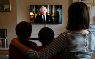 Ben, Isaac and Krystyna Rickett watching a broadcast of King Charles III first address to the nation as the new King following the death of Queen Elizabeth II on Thursday.