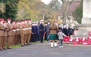 A child lays a wreath after the annual Remembrance Service at York's war memorial