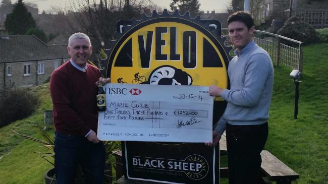 Rob Theakston,  managing director of Black Sheep Brewery, presents a cheque to Mike Hughes, who raised more than £25,000 for Marie Curie nurses