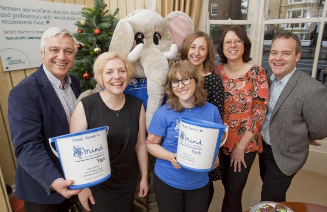 Staff from Partners PR hand a donation over to York Mind
