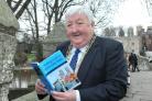 The Lord Mayor of York Councillor Ian Gillies with a copy of A Walking Guide To York’s City Walls by Simon Mattam