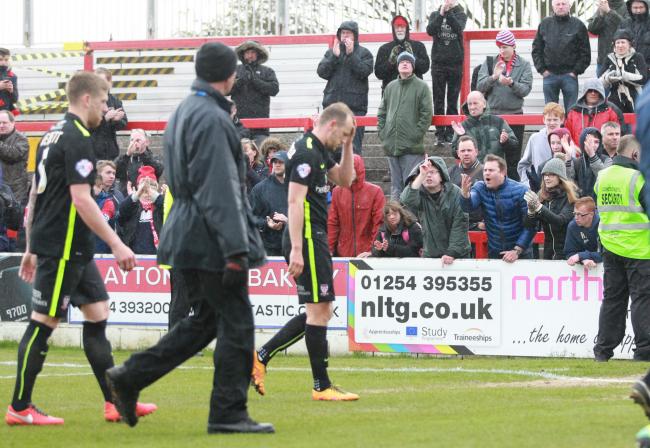 Disconsolate York City players and fans, after the 3-0 defeat at Accrington confirmed relegation. Pictures: Gordon Clayton