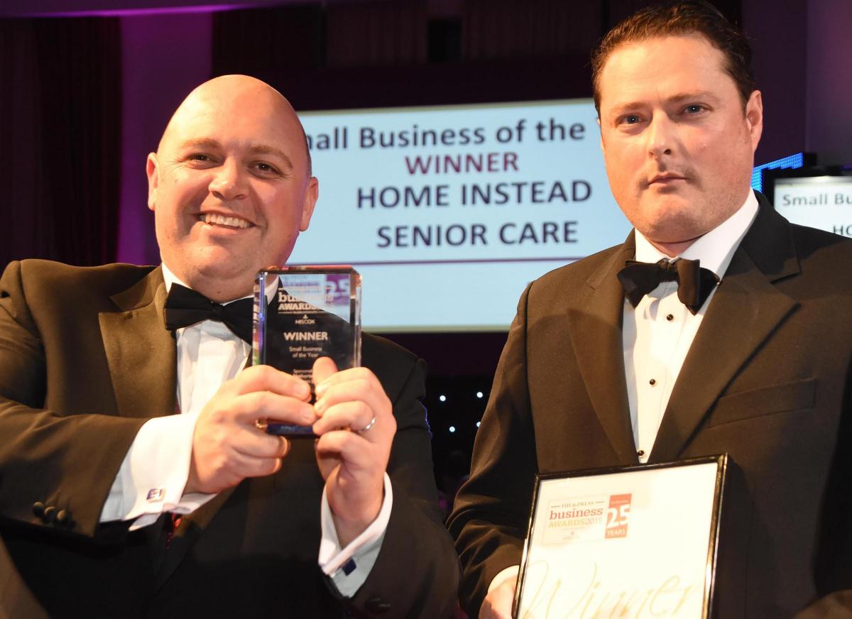 The Press Business Awards 2015. Small Business of the Year Award winner Home Instead Senior Care. Luke Norbury receives the award from Simon Crack from Hetherton's Solicitors. Picture David Harrison.