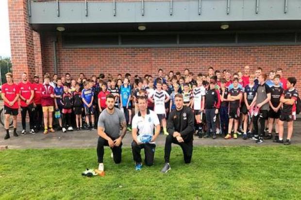 Front, Adam Prentis from the Knights Foundation is flanked by Castleford Tigers stars and former Knights Scholarship graduates Alex Foster, left, and Greg Minikin, pictured along with youngsters and coaches at the launch of the club's new Excel
