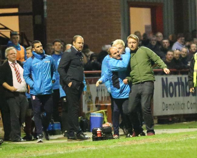 GET A GRIP: York City physio Ian Gallagher restrains an angry away fan at Altrincham after the hosts scored their third goal. Picture: Gordon Clayton