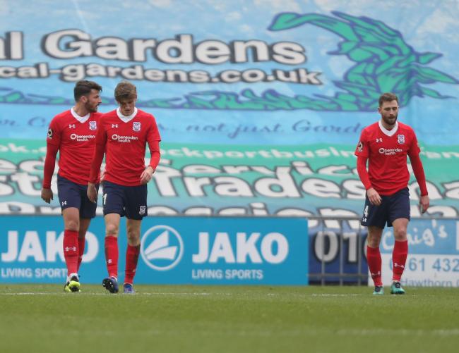 TRAVEL SICK: York City trio Sean Newton, Alex Kempster and Josh Law trudge back towards the halfway line after Stockport's second goal in a 3-1 defeat that was the team's eighth straight league loss on the road. Picture: Gordon Clayton